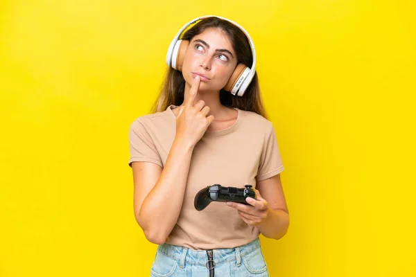 Young Caucasian Woman Playing Video Game Controller Isolated Yellow Background — Stockfoto