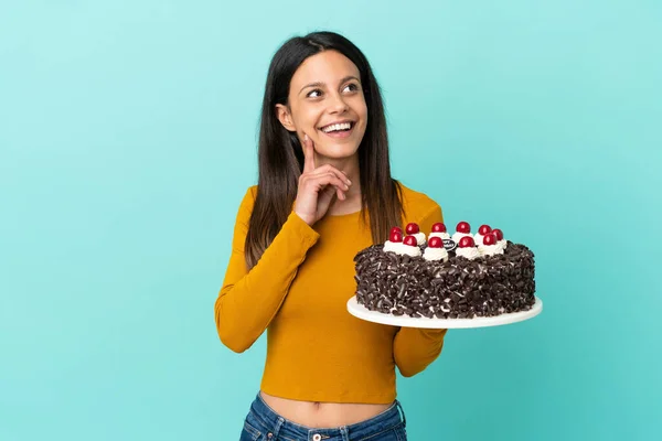 Young Caucasian Woman Holding Birthday Cake Isolated Blue Background Thinking —  Fotos de Stock