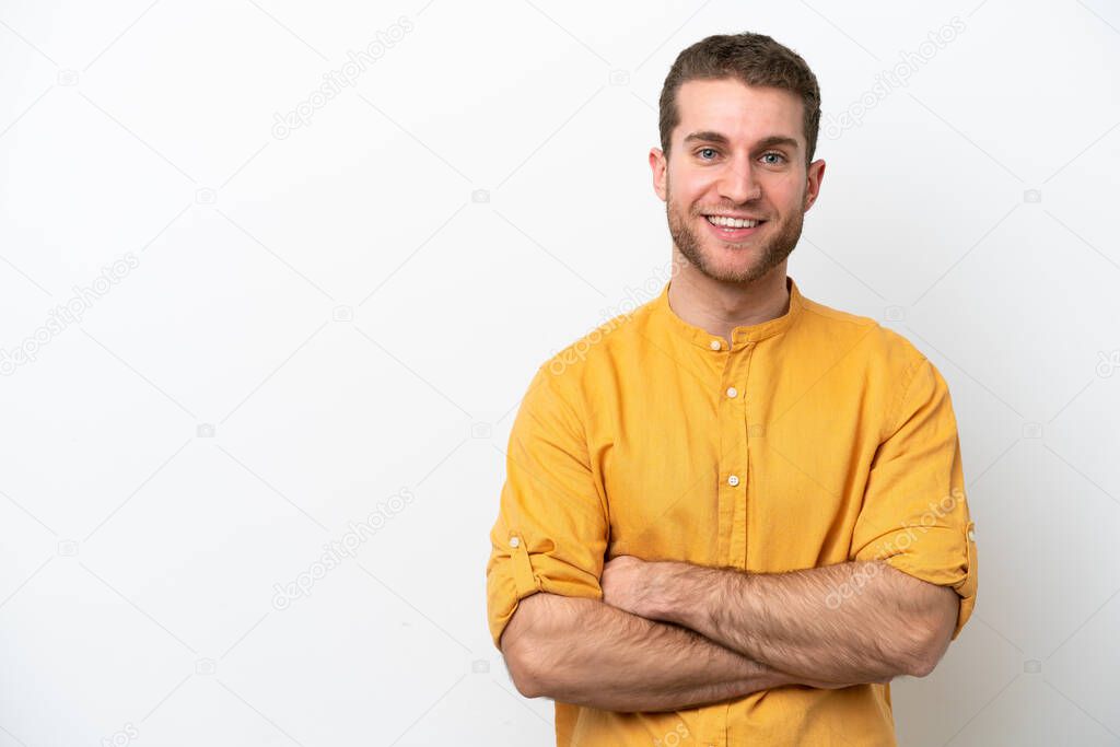 Young caucasian man isolated on white background keeping the arms crossed in frontal position