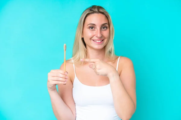 Młoda Biała Kobieta Myje Zęby Wyizolowane Niebieskim Tle Wskazuje — Zdjęcie stockowe