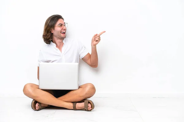 Young Handsome Man Laptop Sitting Floor Isolated White Background Pointing — Foto de Stock