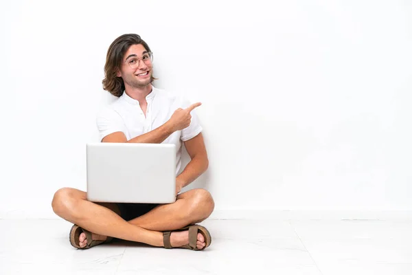 Young Handsome Man Laptop Sitting Floor Isolated White Background Pointing — Fotografia de Stock