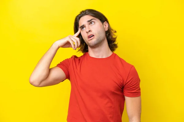 Caucasian Handsome Man Isolated Yellow Background Making Gesture Madness Putting — Zdjęcie stockowe