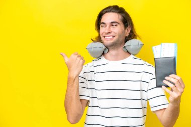 handsome Man with Inflatable Travel Pillow pointing to the side to present a product