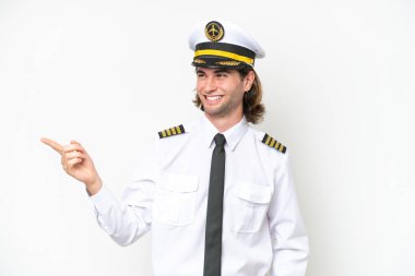 handsome Airplane pilot isolated on white background pointing finger to the side and presenting a product