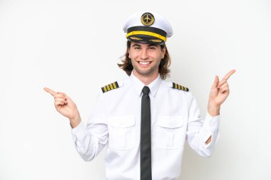 handsome Airplane pilot isolated on white background pointing finger to the laterals and happy