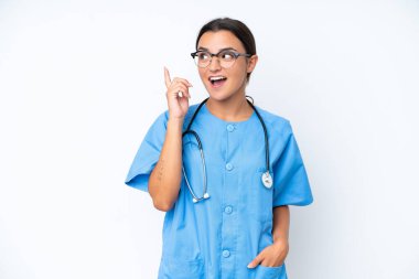 Young nurse woman isolated on white background thinking an idea pointing the finger up