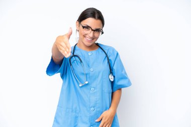 Young nurse woman isolated on white background shaking hands for closing a good deal