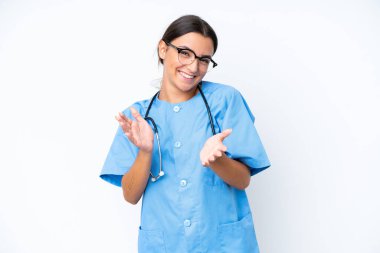 Young nurse woman isolated on white background applauding after presentation in a conference