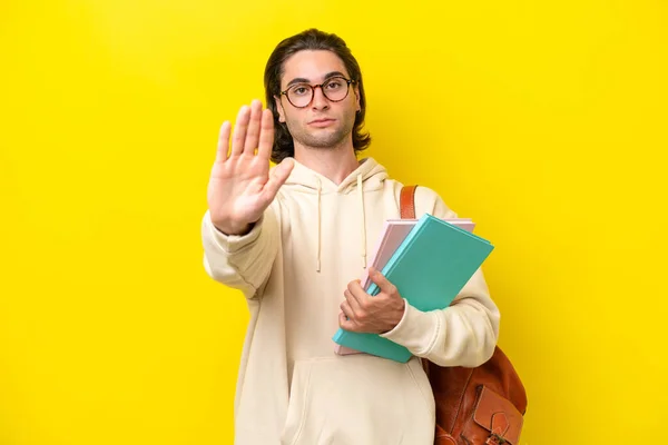 Young Student Handsome Man Isolated Yellow Background Making Stop Gesture — Stock fotografie