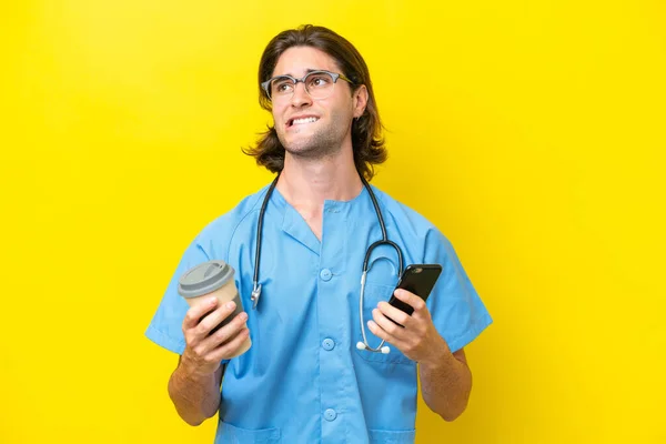 Young Surgeon Caucasian Man Isolated Yellow Background Holding Coffee Take —  Fotos de Stock