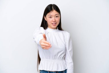 Young Chinese woman isolated on white background shaking hands for closing a good deal