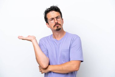 Young man with moustache isolated on white background having doubts
