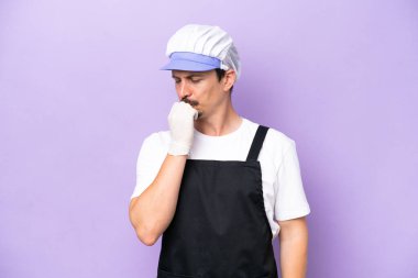 Fishmonger man wearing an apron isolated on purple background having doubts