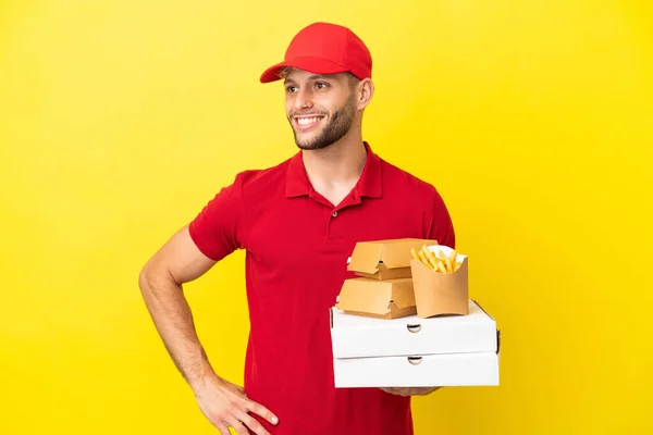 Pizza Delivery Man Picking Pizza Boxes Burgers Isolated Background Posing — Foto de Stock