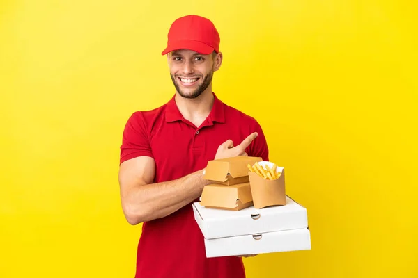 Pizza Delivery Man Picking Pizza Boxes Burgers Isolated Background Pointing — Foto de Stock