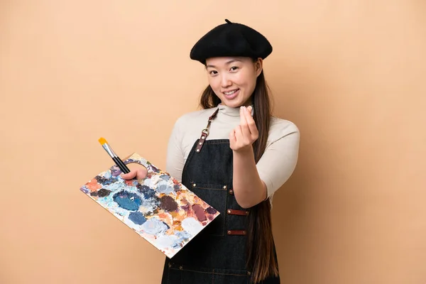 Young Chinese Painter Woman Isolated Beige Background Making Money Gesture — 스톡 사진