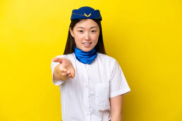 Airplane Chinese Woman Stewardess Isolated Yellow Background Shaking Hands Closing — 图库照片