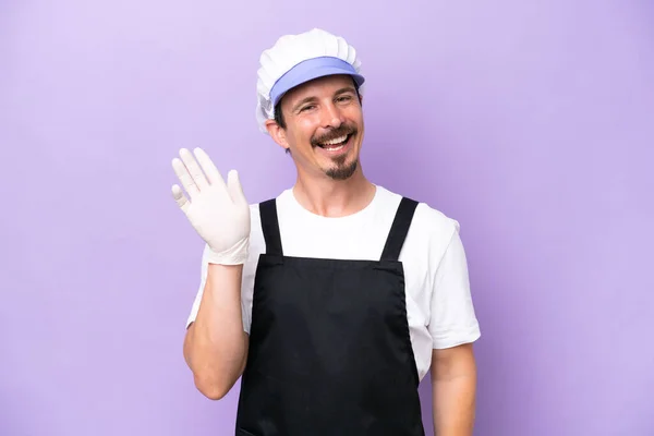 Fishmonger Man Wearing Apron Isolated Purple Background Saluting Hand Happy — Zdjęcie stockowe