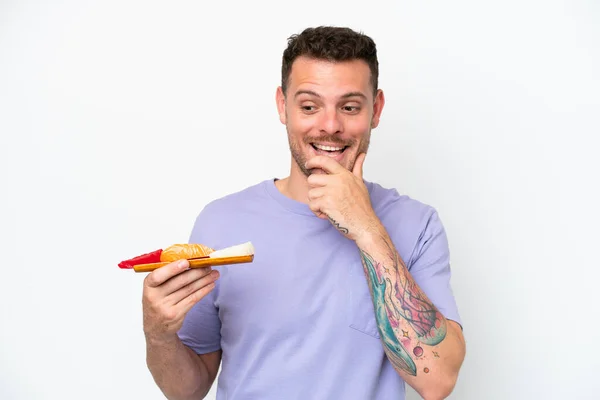 Young Caucasian Man Holding Sashimi Isolated White Background Looking Side — 스톡 사진