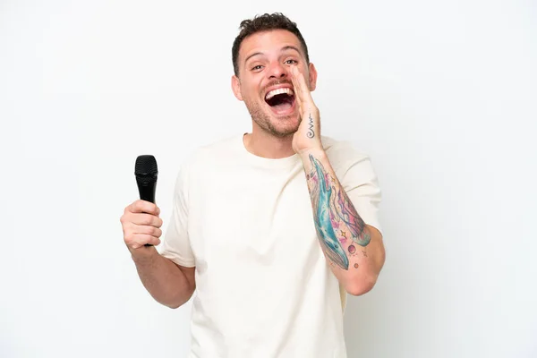 Young Caucasian Singer Man Picking Microphone Isolated White Background Shouting —  Fotos de Stock