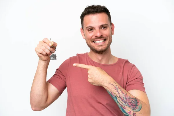 Young Caucasian Man Holding Home Keys Isolated White Background Pointing — 图库照片