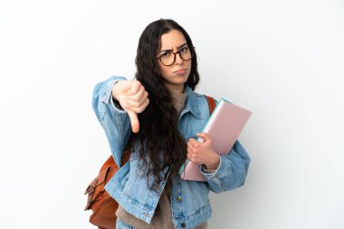 Beyaz arka planda izole edilmiş genç bir bayan başparmağın olumsuz ifadesini gösteriyor.