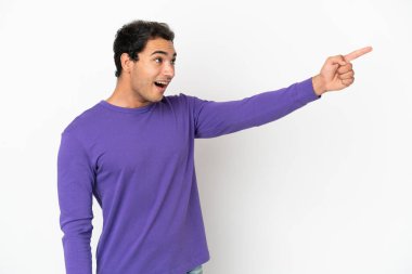 Caucasian handsome man over isolated white background pointing away