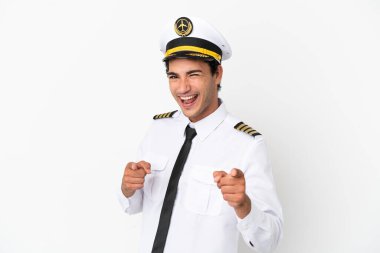 Airplane pilot over isolated white background pointing to the front and smiling
