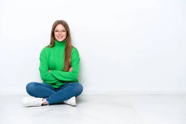Young Caucasian Woman Sitting Floor Isolated White Background Keeping Arms — Stock fotografie