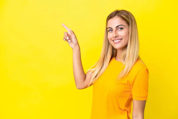 Blonde Uruguayan Girl Isolated Yellow Background Pointing Finger Side — Foto Stock