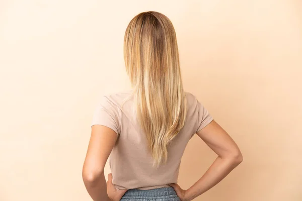 Blonde Uruguayan Girl Isolated Beige Background Back Position — Stockfoto