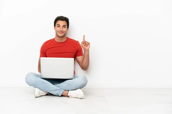 Caucasian Handsome Man Laptop Sitting Floor Pointing Index Finger Great — стокове фото
