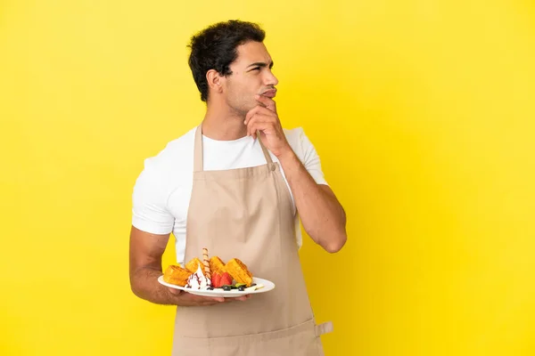 Restaurant Waiter Holding Waffles Isolated Yellow Background Looking — Zdjęcie stockowe