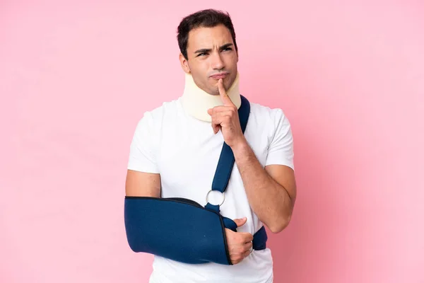 Young Caucasian Man Broken Arm Wearing Sling Isolated Pink Background —  Fotos de Stock