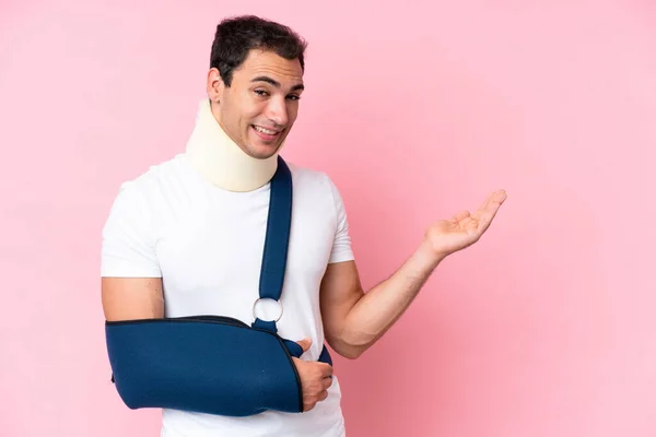 Young Caucasian Man Broken Arm Wearing Sling Isolated Pink Background —  Fotos de Stock