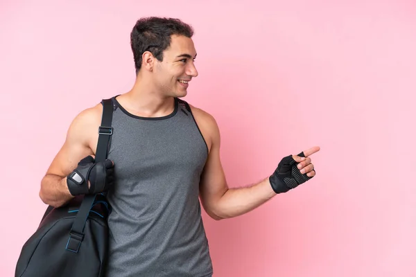 Young Sport Caucasian Man Sport Bag Isolated Pink Background Pointing — Fotografia de Stock