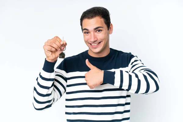 Young Caucasian Man Holding Home Keys Isolated White Background Thumbs — Stockfoto