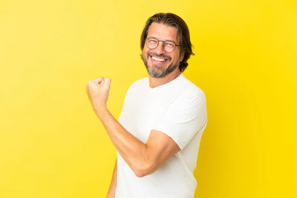 Senior Dutch Man Isolated Yellow Background Doing Strong Gesture — Stock Photo, Image