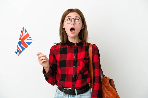 举着英国国旗 身披蓝色背景的年轻女子抬起头 脸上带着惊讶的表情 — 图库照片