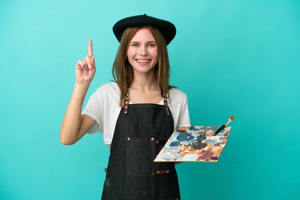 Młoda Artystka Angielski Kobieta Trzyma Paletę Odizolowanych Niebieskim Tle Wskazując — Zdjęcie stockowe