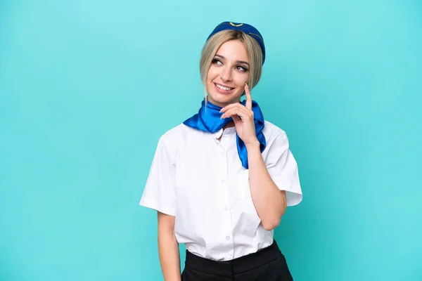 Airplane Blonde Stewardess Woman Isolated Blue Background Thinking Idea While — Stock Photo, Image