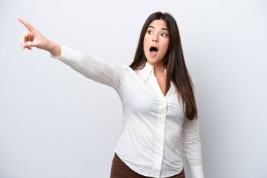 Young Brazilian woman isolated on white background pointing away