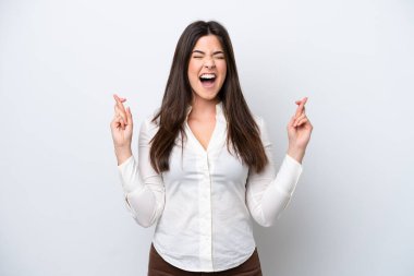 Young Brazilian woman isolated on white background with fingers crossing