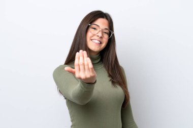 Young Brazilian woman isolated on white background inviting to come with hand. Happy that you came