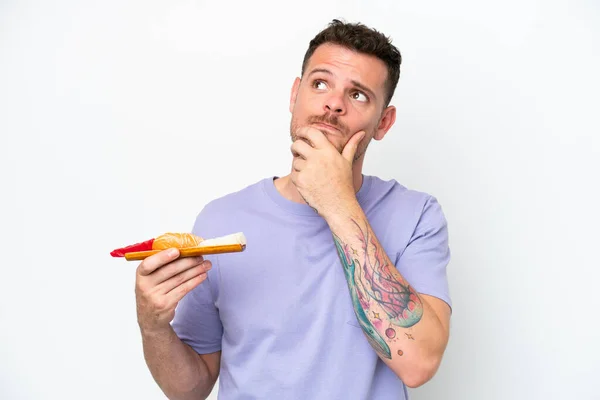 Young Caucasian Man Holding Sashimi Isolated White Background Having Doubts — Stock fotografie