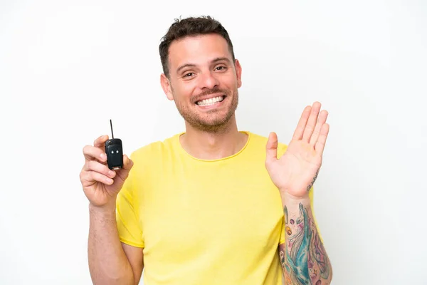 Young Man Holding Car Keys Isolated White Background Saluting Hand — Stockfoto