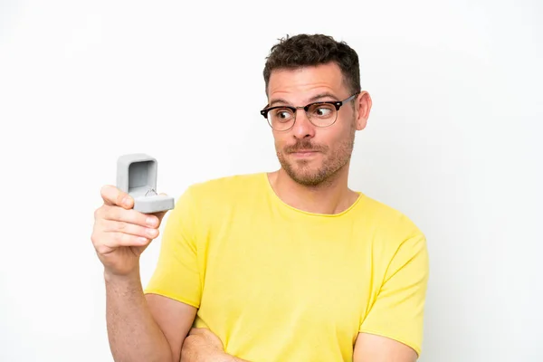 Young Caucasian Man Holding Engagement Ring Isolated White Background Sad — Zdjęcie stockowe