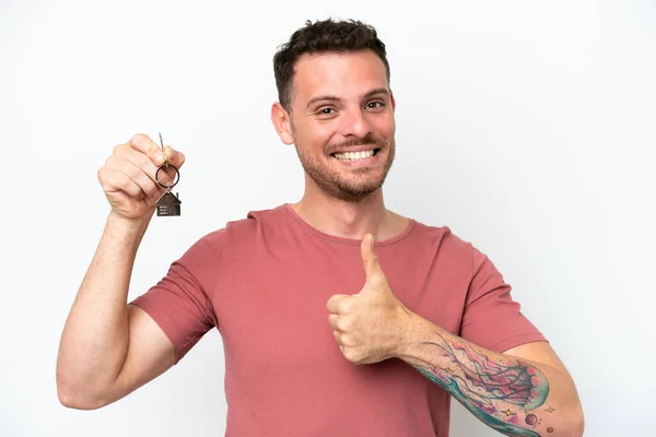 Young Caucasian Man Holding Home Keys Isolated White Background Thumbs — Stockfoto