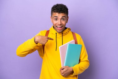 Mor arka planda yüzü sürpriz bir ifadeyle izole edilmiş genç Brezilyalı öğrenci.